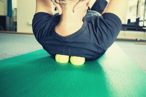 Rub muscle knots in your back by lying on a tennis ball